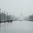File photo shows people walking amid light rain on Kartavya Path in New Delhi
